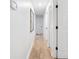 Bright hallway with light wood floors, white walls, and closet at 2556 Arborwood Dr, Valrico, FL 33596