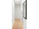 Hallway featuring light wood floors and white walls, creating a bright and airy space at 2556 Arborwood Dr, Valrico, FL 33596