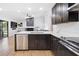 Bright, modern kitchen with stainless steel appliances, dark cabinetry, quartz countertops, and open access to the living area at 2556 Arborwood Dr, Valrico, FL 33596