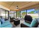 Comfortable screened patio with nice seating, a ceiling fan, and a fire pit at 2556 Arborwood Dr, Valrico, FL 33596