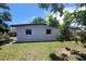 Exterior view of backyard featuring grass and the rear of the house at 8035 Robin Rd, Seminole, FL 33777