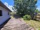 Backyard view of a weathered wooden deck, adjacent to green shrubbery at 8035 Robin Rd, Seminole, FL 33777