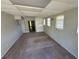 This living room has carpet floors, white walls and ceiling, and several windows for ample natural light at 8035 Robin Rd, Seminole, FL 33777