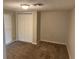 Bedroom with carpet flooring, a double closet, and neutral paint at 9825 Sandstone Ln, Port Richey, FL 34668