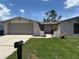 Charming single Gathering home with a two car garage, landscaped yard, and a brick walkway at 9825 Sandstone Ln, Port Richey, FL 34668