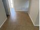 Hallway with neutral colored tile flooring leading to other rooms in the house at 9825 Sandstone Ln, Port Richey, FL 34668