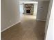 Spacious living room featuring a stone fireplace, neutral tile, and access to other rooms at 9825 Sandstone Ln, Port Richey, FL 34668