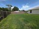 Fenced backyard with grass and wooden fence at 1140 Belmar Ave, Port Charlotte, FL 33948