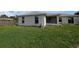 Back exterior of the house with a grass backyard at 1140 Belmar Ave, Port Charlotte, FL 33948