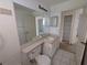 View of a neutrally colored bathroom with a built-in sink and cabinetry at 1140 Belmar Ave, Port Charlotte, FL 33948