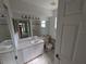Bathroom with accessible toilet features and vanity with mirror, providing functionality and safety at 1140 Belmar Ave, Port Charlotte, FL 33948