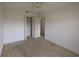 A well-lit bedroom with an ample closet and entry door at 1140 Belmar Ave, Port Charlotte, FL 33948
