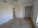 Bedroom with open closet and ensuite bath, offers convenience and storage options at 1140 Belmar Ave, Port Charlotte, FL 33948