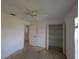 Bedroom with open closet and ensuite bath, offers convenience and storage options at 1140 Belmar Ave, Port Charlotte, FL 33948