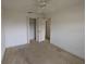 A well-lit bedroom with an ample closet and entry door at 1140 Belmar Ave, Port Charlotte, FL 33948