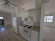 Galley-style kitchen with white appliances, offering a functional cooking space at 1140 Belmar Ave, Port Charlotte, FL 33948