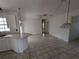 Spacious kitchen with eat-in counter, providing seating and open access to adjacent room at 1140 Belmar Ave, Port Charlotte, FL 33948