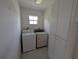 Functional laundry room with washer, dryer, and storage cabinets, for convenient chore management at 1140 Belmar Ave, Port Charlotte, FL 33948