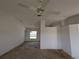 Living room with neutral walls, white ceiling fan, natural light, and space for personalized design at 1140 Belmar Ave, Port Charlotte, FL 33948