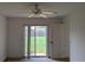Bedroom featuring a ceiling fan and a sliding door leading to the backyard at 1140 Belmar Ave, Port Charlotte, FL 33948