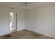 Main bedroom with neutral walls and ceiling fan, leading to the main bathroom at 1140 Belmar Ave, Port Charlotte, FL 33948
