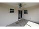 Covered patio featuring a ceiling fan and sliding glass door at 1140 Belmar Ave, Port Charlotte, FL 33948