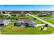 Expansive aerial view of a well-landscaped house in a tranquil neighborhood with ponds, manicured lawns, and lush trees at 142 Broadmoor Ln, Rotonda West, FL 33947