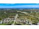 An aerial showcases a coastal community with winding roads and lush landscape near the Gulf at 142 Broadmoor Ln, Rotonda West, FL 33947