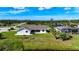 Aerial view of a well-maintained home with green lawn and landscaping at 142 Broadmoor Ln, Rotonda West, FL 33947