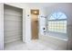 This bathroom boasts a tub, a shower with glass door, and an organized storage closet offering functionality at 142 Broadmoor Ln, Rotonda West, FL 33947