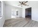 A serene room with a ceiling fan, sliding glass door, and a doorway, enhancing the sense of spaciousness and flow at 142 Broadmoor Ln, Rotonda West, FL 33947