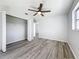 Spacious bedroom with wood-look floors, a ceiling fan, and a walk-in closet at 142 Broadmoor Ln, Rotonda West, FL 33947
