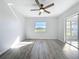 An airy room with a ceiling fan and a sliding glass door offers natural light and access to outdoor views at 142 Broadmoor Ln, Rotonda West, FL 33947
