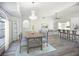 Bright dining room features a chandelier, shell-pattern rug, and an archway to the living area at 142 Broadmoor Ln, Rotonda West, FL 33947