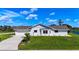 Well-maintained home features a manicured lawn and an attached two-car garage at 142 Broadmoor Ln, Rotonda West, FL 33947