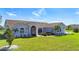 Inviting single-Gathering home boasting a well-maintained lawn, mature landscaping, and a secure screened front entry at 142 Broadmoor Ln, Rotonda West, FL 33947