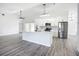 Modern kitchen with white cabinets, stainless steel appliances, and a breakfast bar island at 142 Broadmoor Ln, Rotonda West, FL 33947