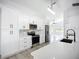 Bright kitchen boasts modern appliances, stylish backsplash, and ample counter space at 142 Broadmoor Ln, Rotonda West, FL 33947