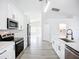 Well-lit kitchen with stainless steel appliances and white countertops and cabinetry at 142 Broadmoor Ln, Rotonda West, FL 33947