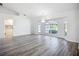 Open living space with large windows, a chandelier, and access to other rooms at 142 Broadmoor Ln, Rotonda West, FL 33947