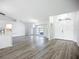 Bright and spacious living area with hardwood flooring, elegant chandeliers, and a clear view of the front yard at 142 Broadmoor Ln, Rotonda West, FL 33947