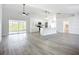 Spacious living room with modern finishes, ceiling fan, and sliding glass doors to lanai at 142 Broadmoor Ln, Rotonda West, FL 33947