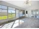 Bright sunroom with tile flooring, ceiling fan, and views of the yard at 142 Broadmoor Ln, Rotonda West, FL 33947