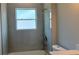 Bright bathroom with tile surround, window, tub, and shower; a clean, functional space at 1495 Craleigh St, North Port, FL 34288