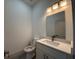 Half bathroom with sleek fixtures, including a quartz countertop and modern sink and lighting at 1495 Craleigh St, North Port, FL 34288