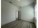 Bedroom with wood floors, window, and a doorway leading to another room at 1495 Craleigh St, North Port, FL 34288