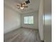 Bedroom with wood-look floors, ceiling fan and recessed lights at 1495 Craleigh St, North Port, FL 34288