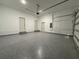 Spacious garage featuring an epoxy floor, multiple doors, and a clean, well-lit environment at 1495 Craleigh St, North Port, FL 34288