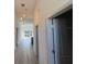 Hallway featuring wood floors, modern lighting, and access to various rooms at 1495 Craleigh St, North Port, FL 34288