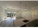 Modern kitchen with a center island, pendant lighting, and stainless steel sink at 1495 Craleigh St, North Port, FL 34288